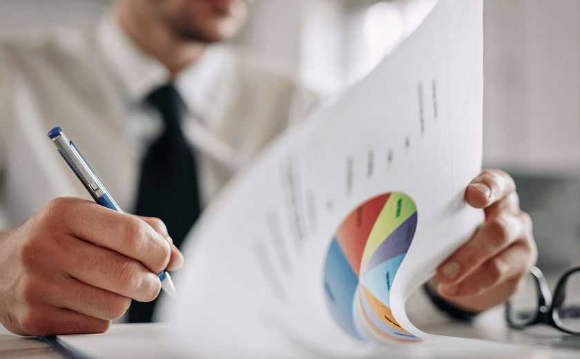 close-up-entrepreneur-going-through-business-reports-taking-notes-office 1.png