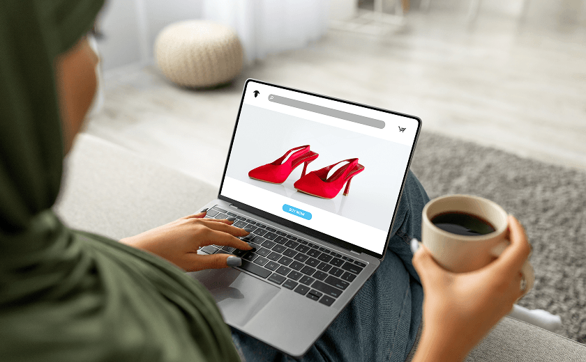 young-arab-woman-hijab-using-laptop-computer-with-fashion-store-screen-drinking-coffee-home 1.png