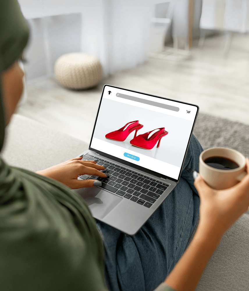 young-arab-woman-hijab-using-laptop-computer-with-fashion-store-screen-drinking-coffee-home 2.png